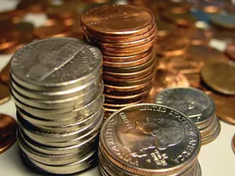 Piles of pennies, nickels, dimes, and quarterlies